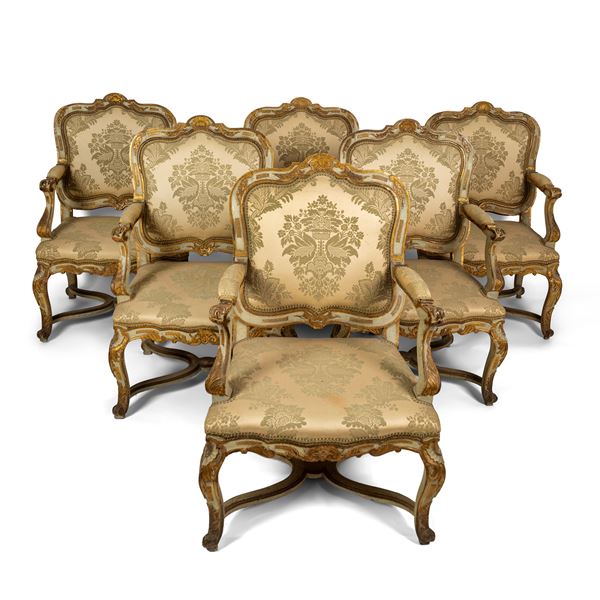 Sei poltrone e uno sgabello in legno laccato avorio e dorato, fine del XVIII secolo