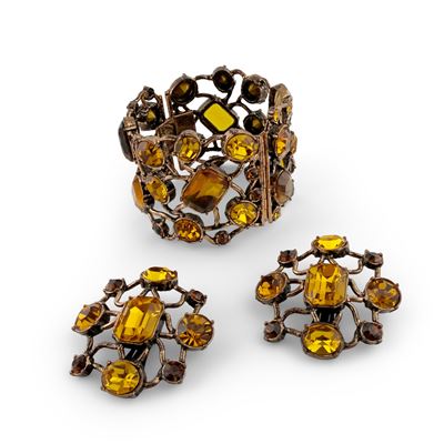 De Liguoro, Demi-parure con bracciale rigido e orecchini in metallo brunito a reticolo con pietre...
