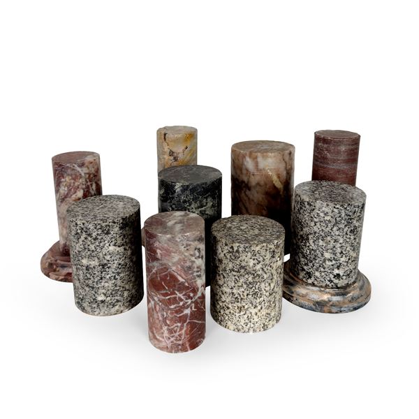 Nove antiche basette cilindriche in marmi diversi