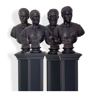 Quattro busti in bronzo di imperatori romani, con base in legno ebanizzato