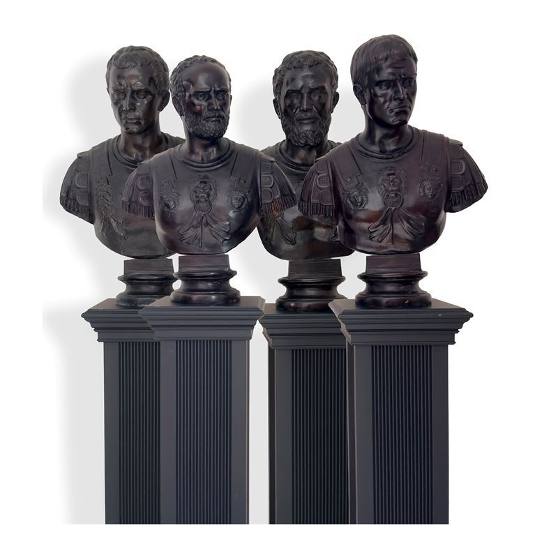 Quattro busti in bronzo di imperatori romani, con base in legno ebanizzato