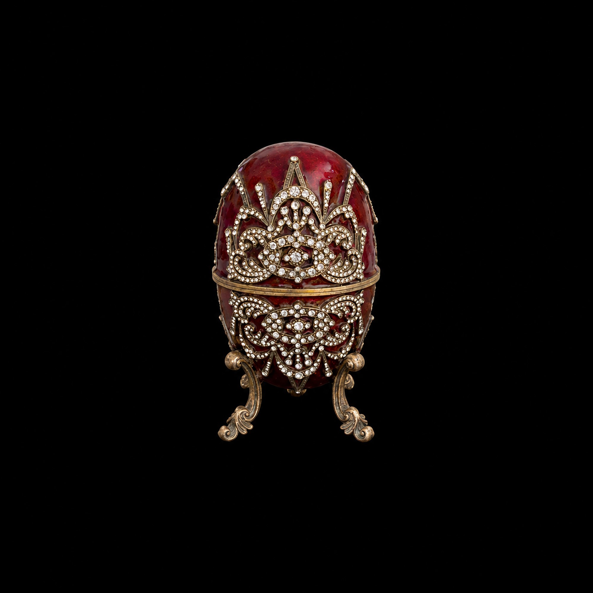 Bolliromiti, Contenitore a forma di uovo in metallo dorato e smalto rosso con carillon a giostra,...